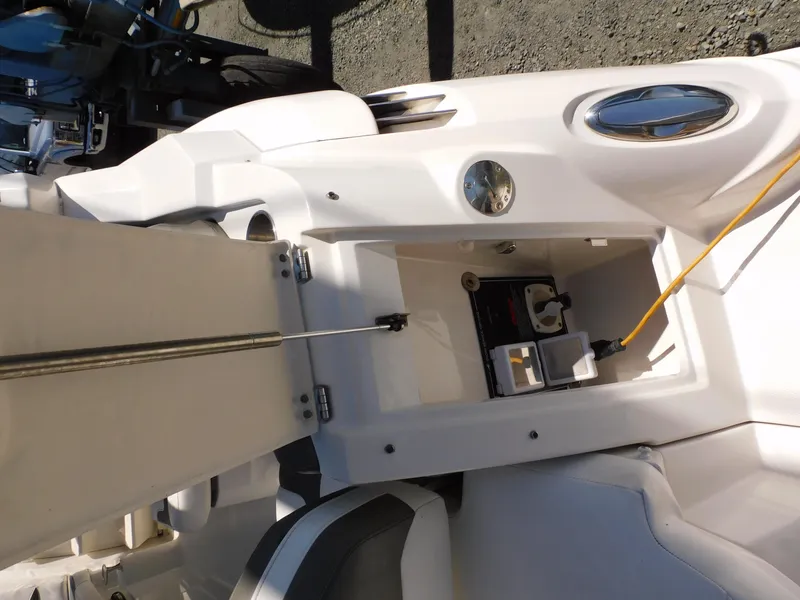 Slide: The Image of Open storage compartment on a 2011 Monterey 260 SCR boat, showing interior details and wiring. - 28