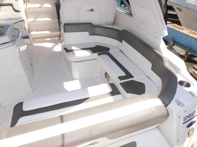 Slide: The Image of 2011 Monterey 260 SCR boat interior with white and gray seating arrangement. - 32