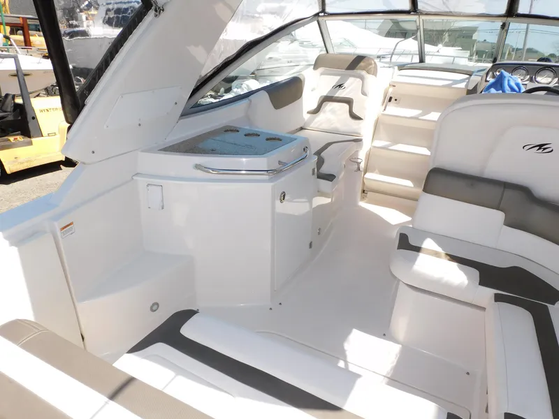 Slide: The Image of 2011 Monterey 260 SCR boat interior with white seating and helm area. - 33