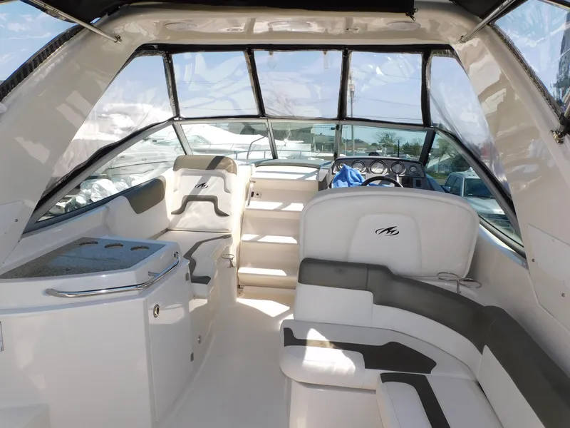 Slide: The Image of 2011 Monterey 260 SCR boat interior with seating and helm, featuring modern design elements. - 34