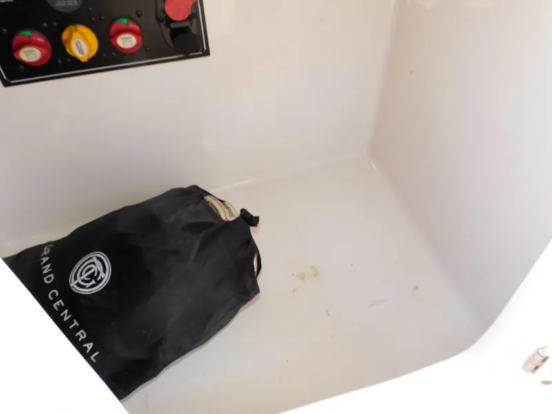 Slide: The Image of Storage compartment in 2011 Monterey 260 SCR boat with control panel and black bag. - 44