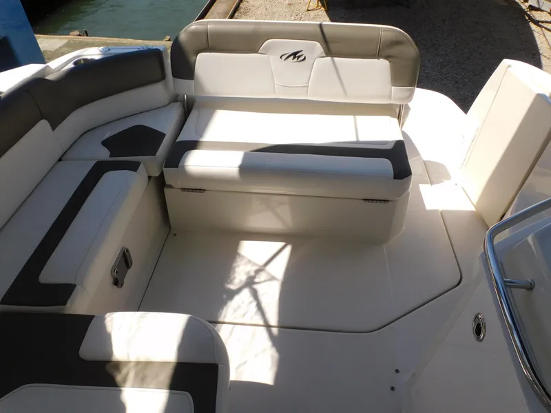 Slide: The Image of 2011 Monterey 260 SCR boat interior with cushioned seating and sleek design. - 45