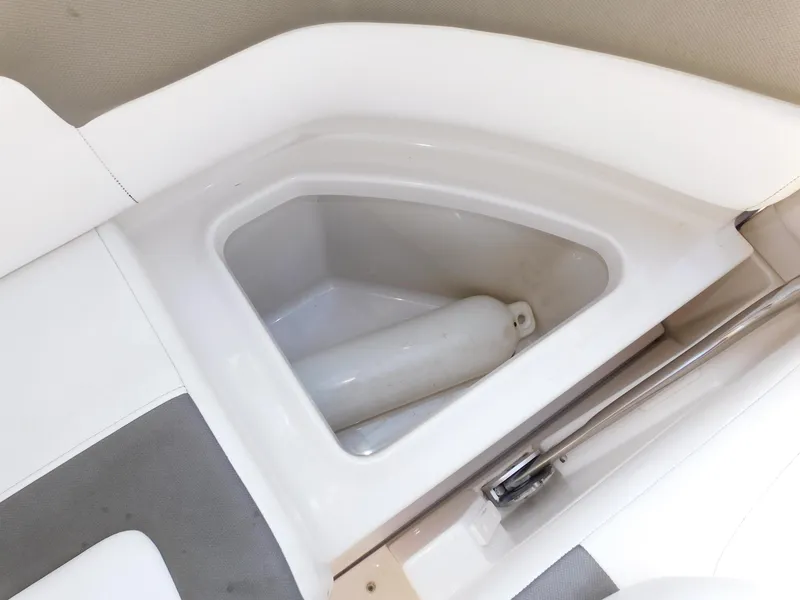 Slide: The Image of Storage compartment on a 2011 Monterey 260 SCR boat, featuring a white fender. - 47