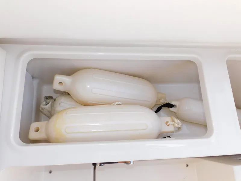 Slide: The Image of Storage compartment with boat fenders on a 2011 Monterey 260 SCR. - 48