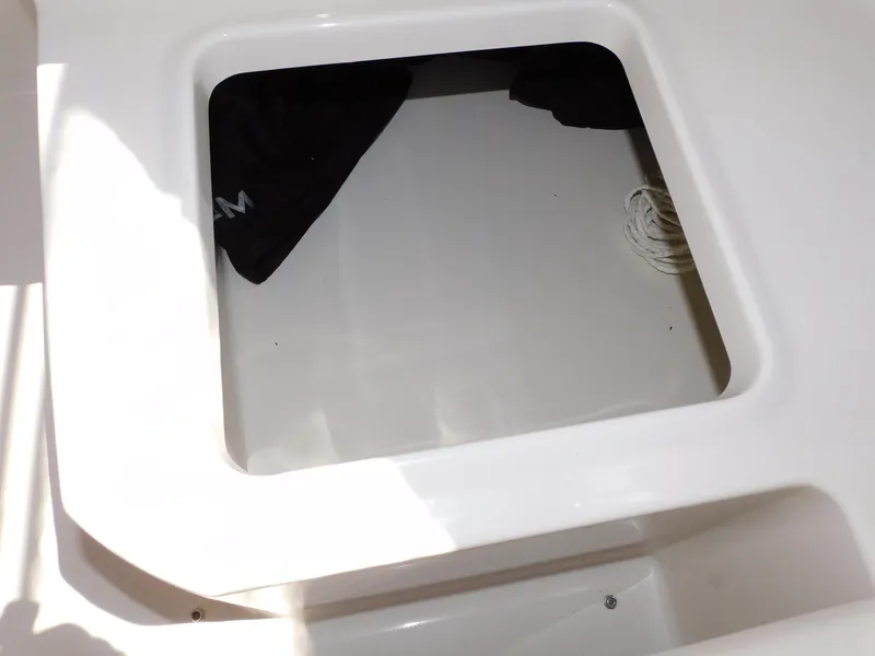 Slide: The Image of Storage compartment on a 2011 Monterey 260 SCR boat, featuring a clean, white interior. - 49