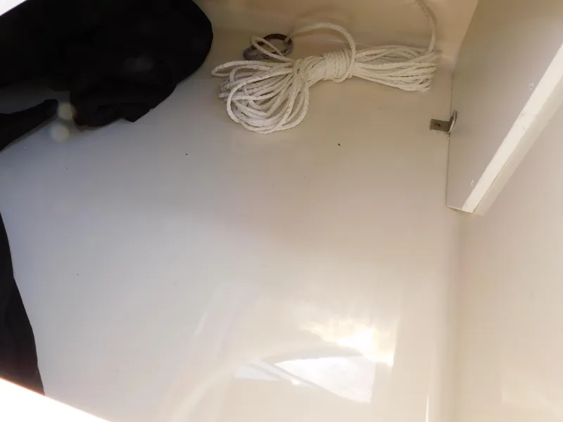 Slide: The Image of Storage compartment in a 2011 Monterey 260 SCR boat with coiled rope. - 50