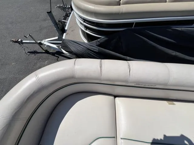 Slide: The Image of Pontoon boat interior, Sanpan 2500R, 1999 model, with beige seating and trailer. - 5