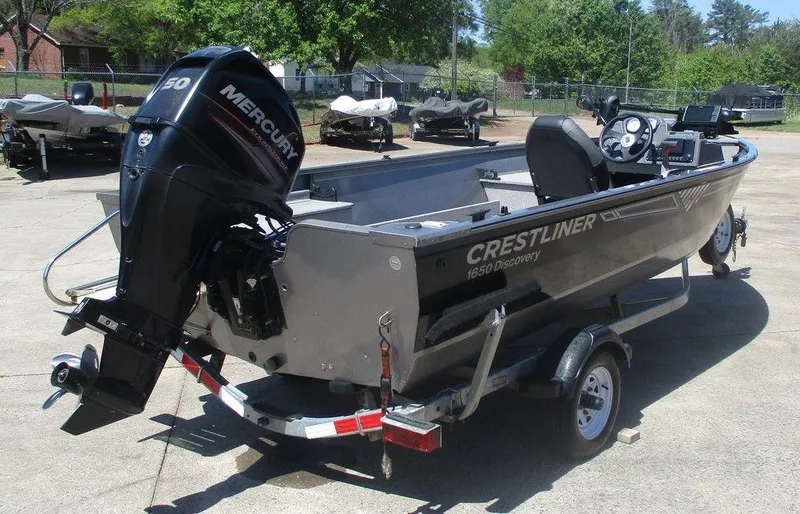 Slide: The Image of 2018 Crestliner 1450 Discovery Side Console boat on trailer with Mercury outboard motor. - 3
