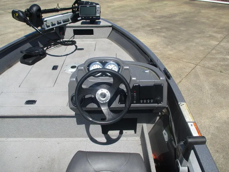 Slide: The Image of 2018 Crestliner 1450 Discovery Side Console boat interior with steering wheel and dashboard. - 6