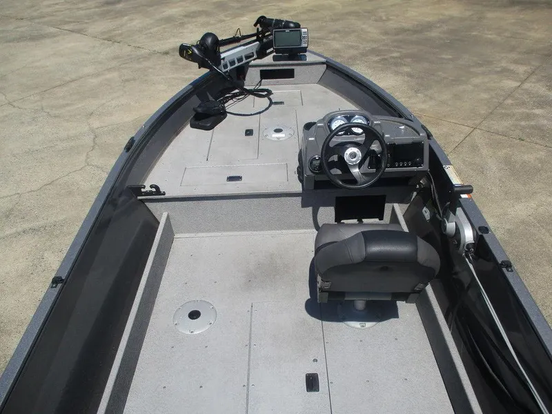 Slide: The Image of 2018 Crestliner 1450 Discovery Side Console boat interior with steering wheel and seating. - 7