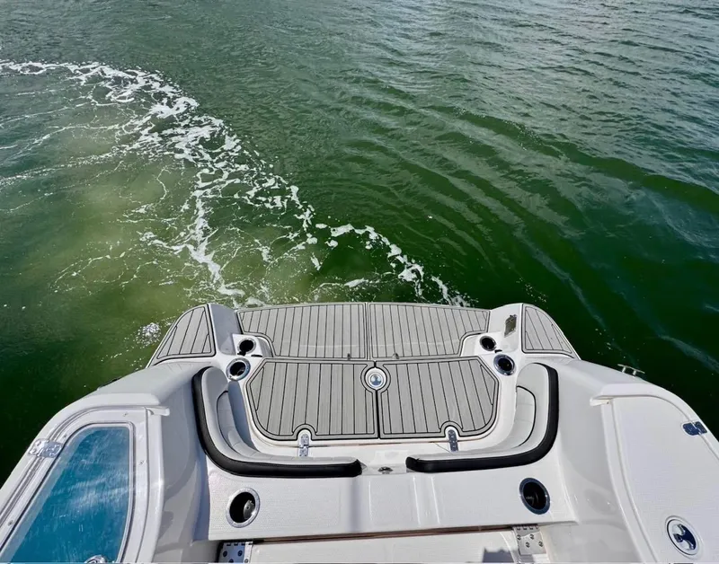 Slide: The Image of 2023 Yamaha Boats 255 FSH Sport E, rear view on water, showcasing swim platform. - 12