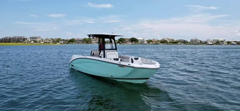 Slide: The Image of 2023 Yamaha Boats 255 FSH Sport E on calm water, showcasing sleek design and modern features. - 8