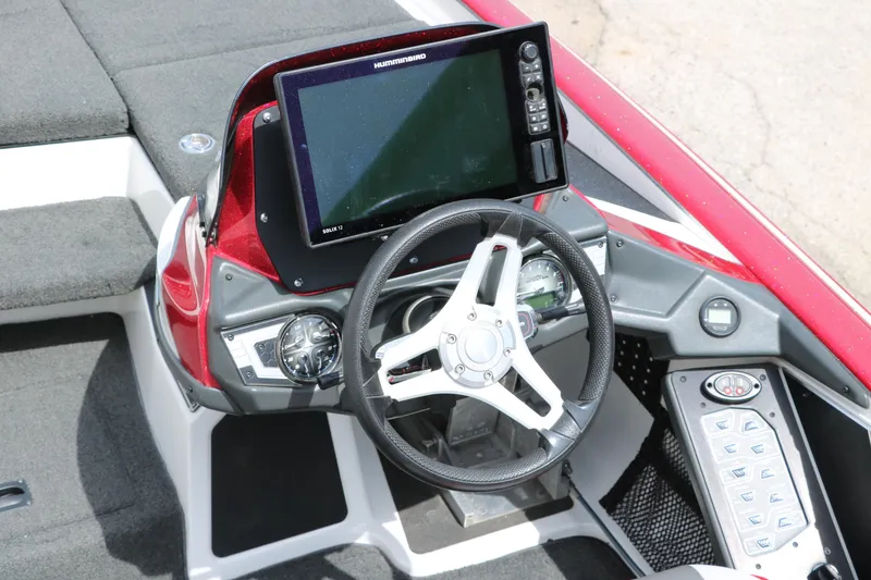 Slide: The Image of 2019 Skeeter FX20 boat dashboard with steering wheel and electronic display. - 19