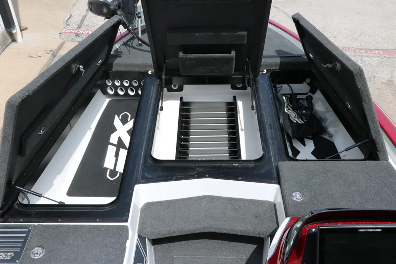 Slide: The Image of 2019 Skeeter FX20 boat storage compartments open, showcasing organized interior layout. - 24