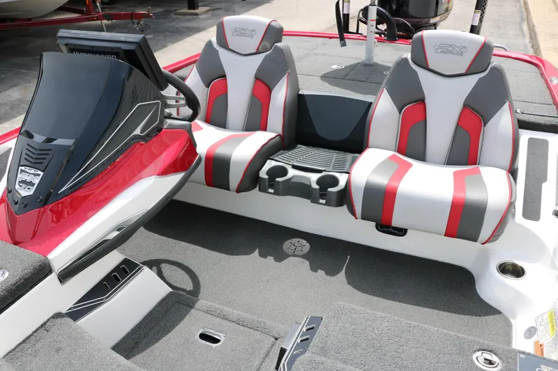 Slide: The Image of 2019 Skeeter FX20 boat interior with red and gray seats, console, and cup holders. - 28