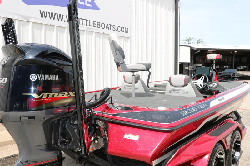 Slide: The Image of 2019 Skeeter FX20 bass boat with Yamaha VMAX engine, parked near a boat dealership. - 3