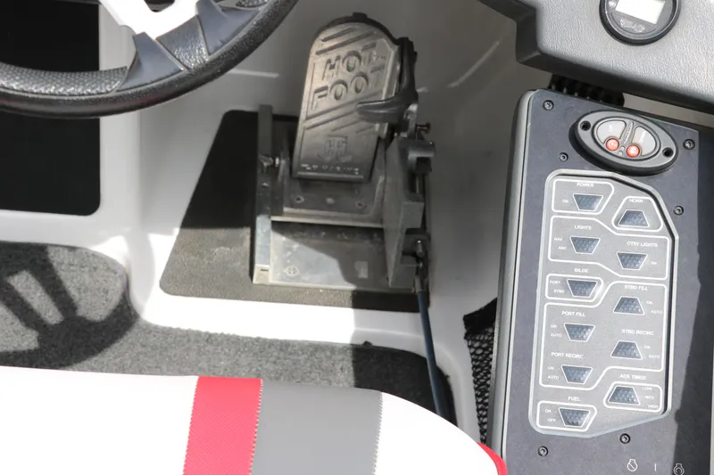 Slide: The Image of 2019 Skeeter FX20 boat cockpit with steering wheel, foot pedal, and control panel. - 30