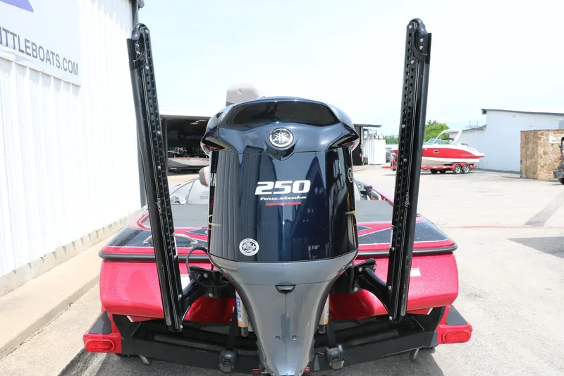 Slide: The Image of 2019 Skeeter FX20 boat with 250 horsepower engine, rear view in a marina setting. - 4