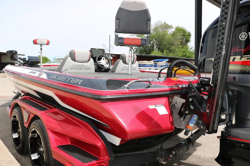 Slide: The Image of 2019 Skeeter FX20 boat in vibrant red, featuring dual seats and a sleek design. - 6