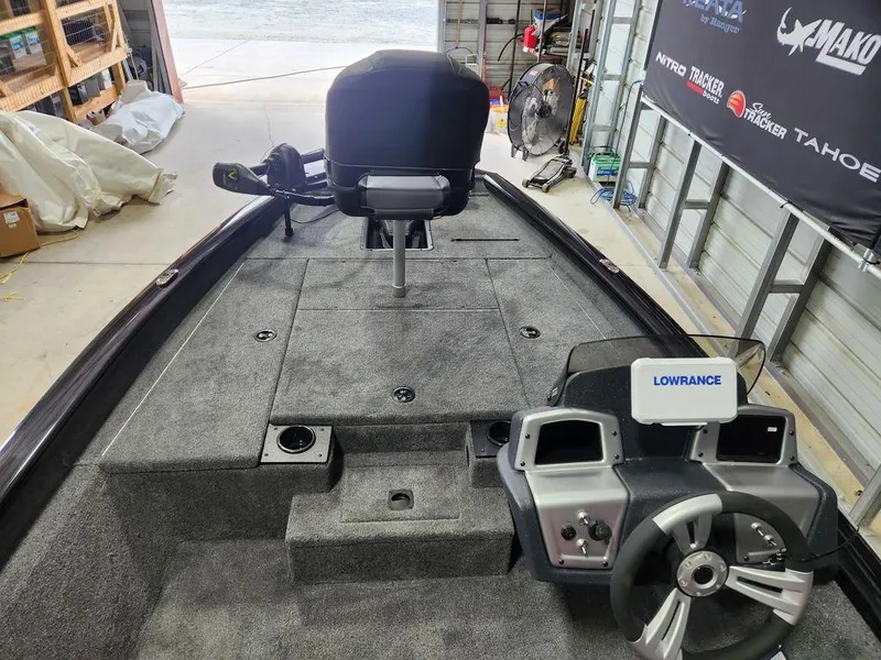 Slide: The Image of 2025 Tracker Pro Team™ 175 Tournament Edition boat interior with steering wheel and Lowrance system. - 7