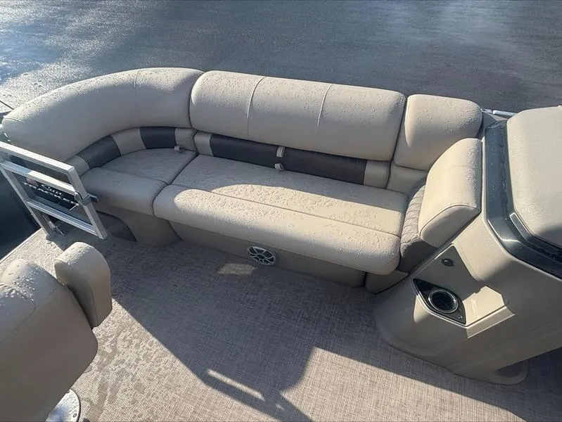 Slide: The Image of 2025 Sun Tracker SF 20 DLX pontoon boat interior with beige seating and cup holder. - 4