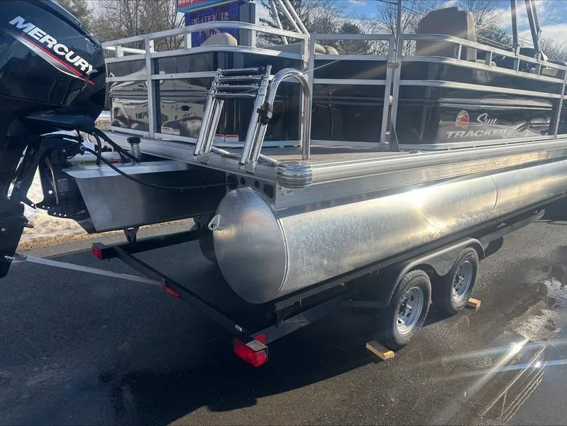 Slide: The Image of 2025 Sun Tracker SF 20 DLX pontoon boat on trailer with Mercury outboard motor. - 6
