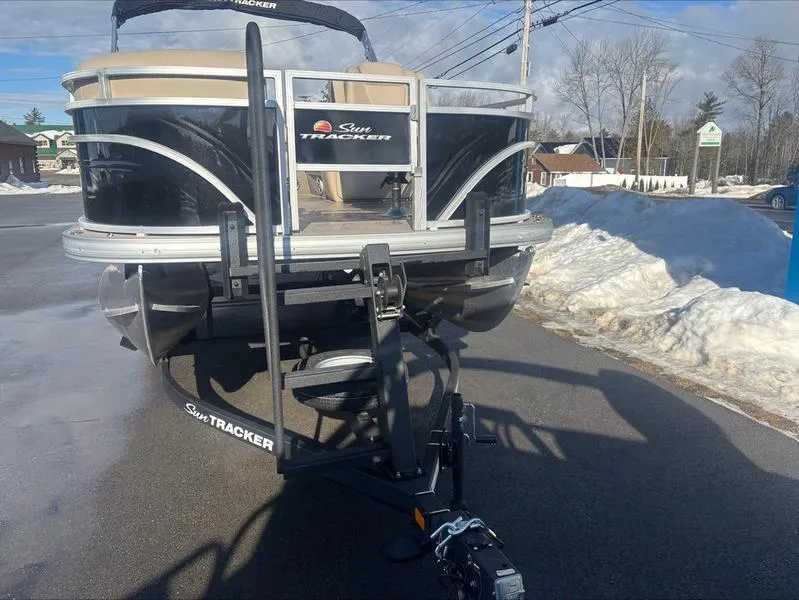 Slide: The Image of 2025 Sun Tracker SF 20 DLX pontoon boat on trailer in snowy parking lot. - 8