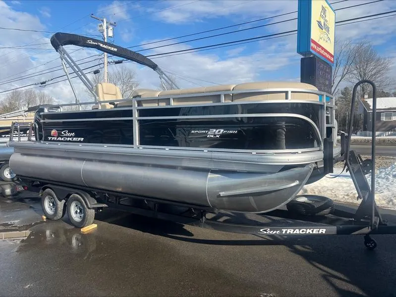 Slide: The Image of 2025 Sun Tracker SF 20 DLX pontoon boat on trailer, parked outdoors. - 9