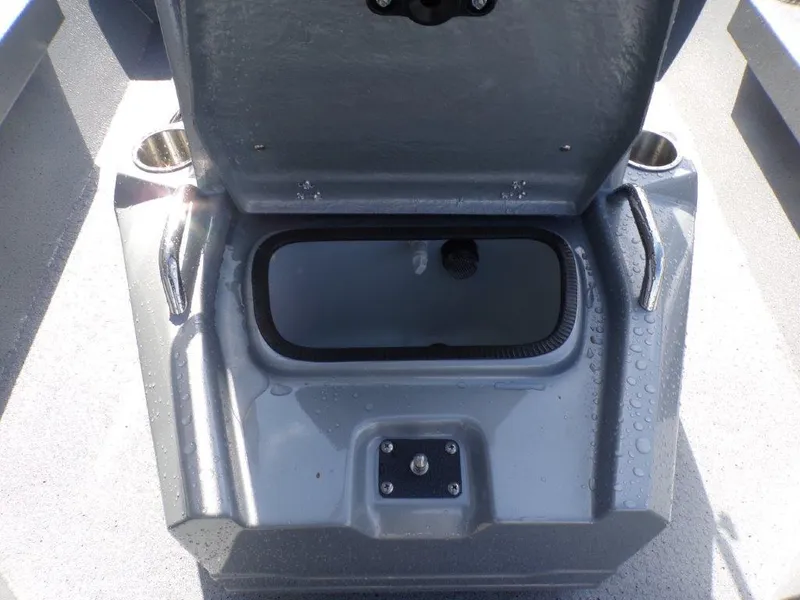 Slide: The Image of 2025 Xpress H20BAY boat storage compartment with open lid and cup holders. - 14