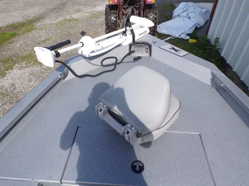 Slide: The Image of 2025 Xpress H20BAY boat deck with trolling motor and seat, parked outdoors. - 15