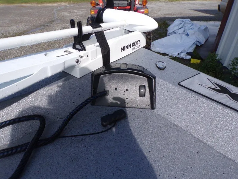 Slide: The Image of 2025 Xpress H20BAY boat with Minn Kota trolling motor on deck. - 17