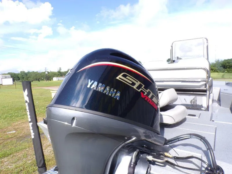 Slide: The Image of 2025 Xpress H20BAY boat with Yamaha outboard motor on a sunny day. - 4