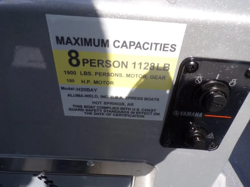 Slide: The Image of 2025 Xpress H20BAY boat capacity label, 8 persons, 1128 lbs, 150 HP motor. - 6