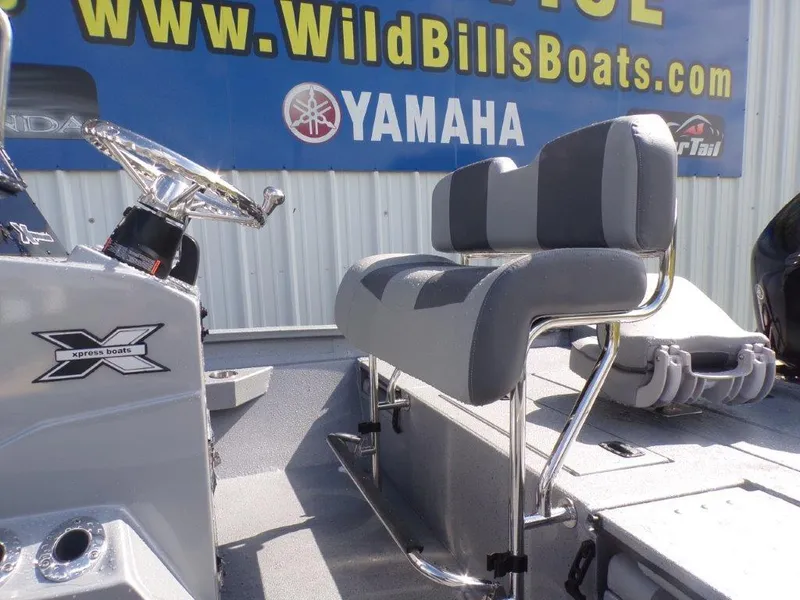 Slide: The Image of 2025 Xpress H20BAY boat interior with gray seating and steering wheel, displayed at Wild Bill's Boats. - 8