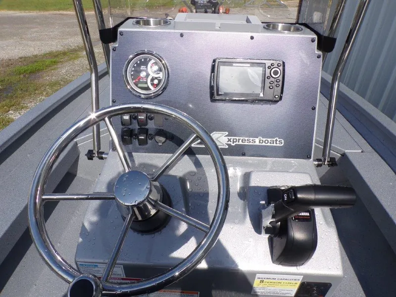 Slide: The Image of 2025 Xpress H20BAY boat dashboard with steering wheel and control panel. - 9