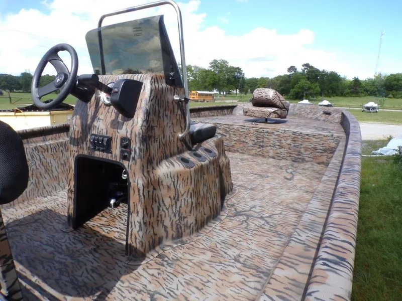 Slide: The Image of 2025 Xpress XP20CC boat with camouflage design, featuring a central console and steering wheel. - 12