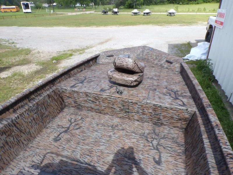 Slide: The Image of 2025 Xpress XP20CC boat with camouflage interior, parked outdoors. - 14