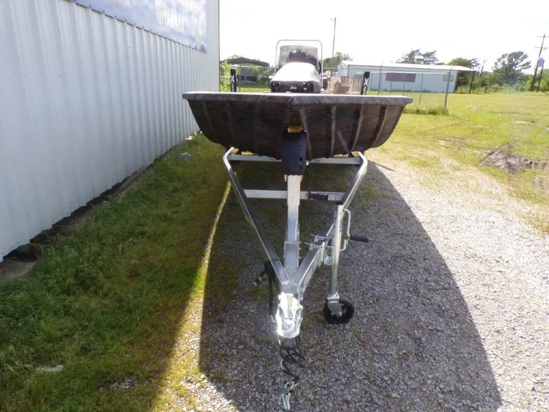 Slide: The Image of 2025 Xpress XP20CC boat on trailer, parked outdoors near a building. - 5