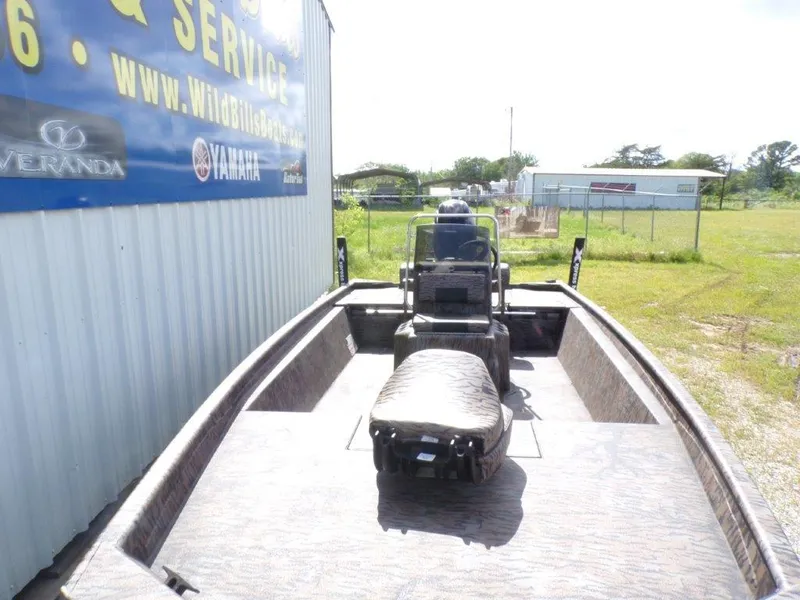 Slide: The Image of 2025 Xpress XP20CC boat docked near a service center, showcasing its spacious interior. - 6