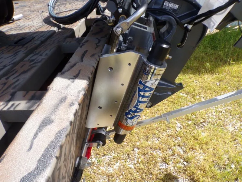 Slide: The Image of 2025 Xpress XP20CC boat with Atlas hydraulic jack plate on grassy surface. - 7