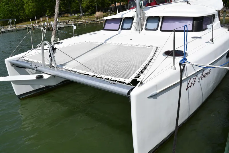 The Image of 2014 Fountaine Pajot Mahe 36 Evolution catamaran docked on calm water. - 0