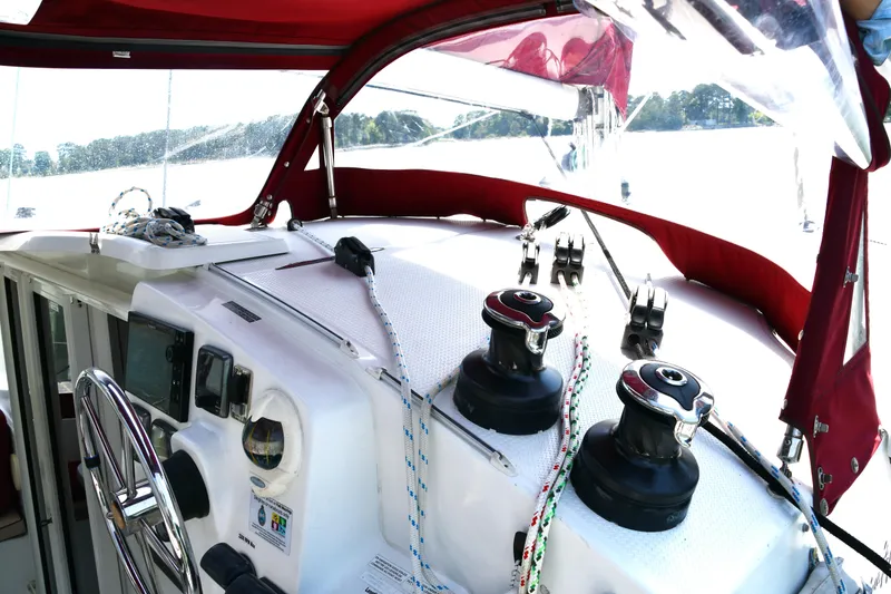 Slide: The Image of 2014 Fountaine Pajot Mahe 36 Evolution yacht cockpit with red canopy and sailing equipment. - 10