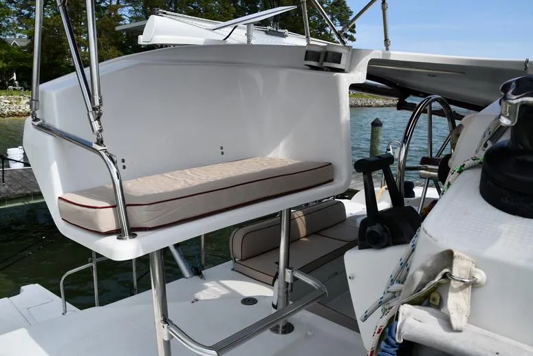 Slide: The Image of 2014 Fountaine Pajot Mahe 36 Evolution catamaran cockpit with seating and steering wheel. - 13
