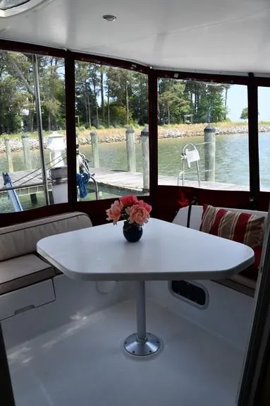 Slide: The Image of Interior of 2014 Fountaine Pajot Mahe 36 Evolution with table and seating, overlooking marina. - 17