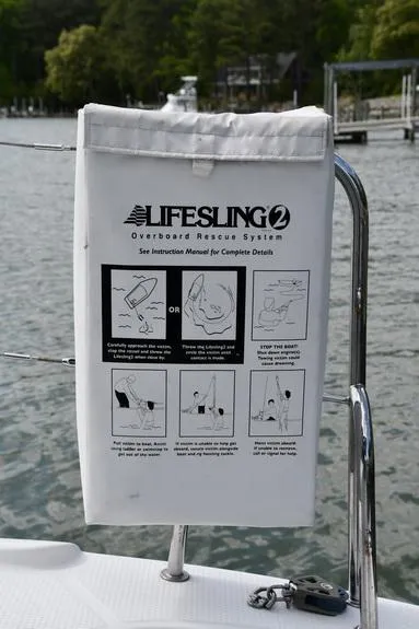 Slide: The Image of Lifesling 2 rescue system on 2014 Fountaine Pajot Mahe 36 Evolution catamaran, docked by water. - 32