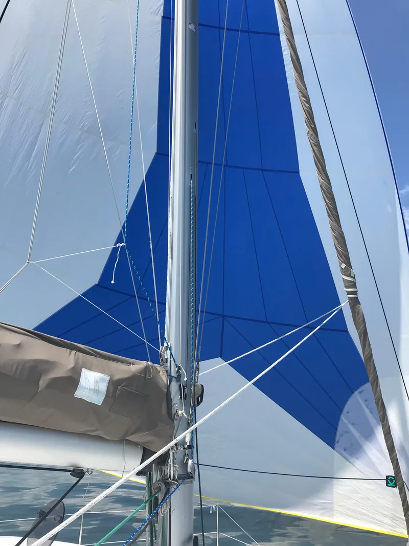 Slide: The Image of Sailing on a 2014 Fountaine Pajot Mahe 36 Evolution with blue and white sails. - 34