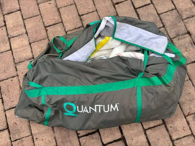 Slide: The Image of Bag labeled "Quantum" on brick surface, containing sailing equipment. - 35