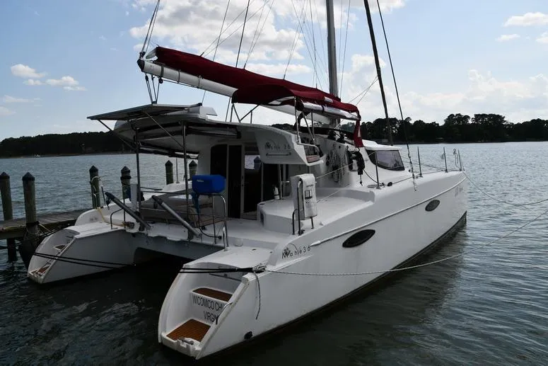 Slide: The Image of 2014 Fountaine Pajot Mahe 36 Evolution catamaran docked on calm water. - 4