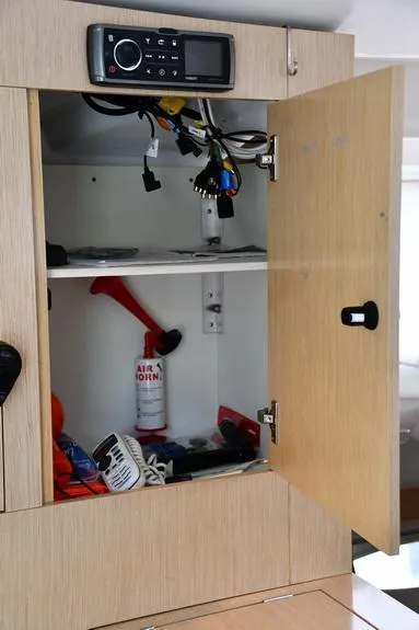 Slide: The Image of Open cabinet on 2014 Fountaine Pajot Mahe 36 Evolution yacht, showing electronics and safety equipment. - 45
