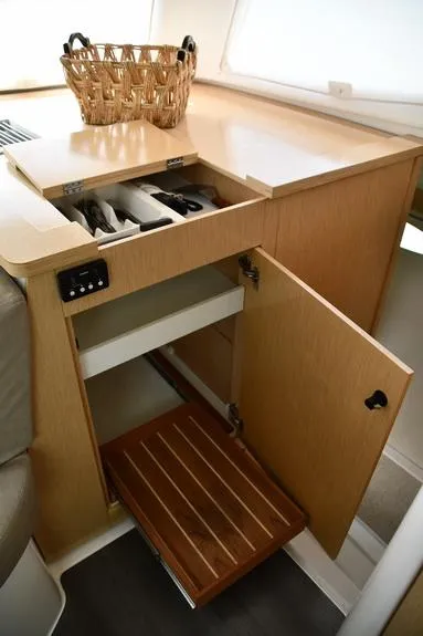 Slide: The Image of Interior of 2014 Fountaine Pajot Mahe 36 Evolution with open cabinet and wicker basket. - 47